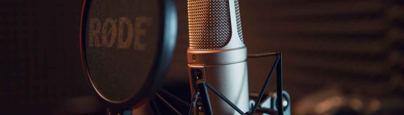 silver dynamic microphone on black microphone stand