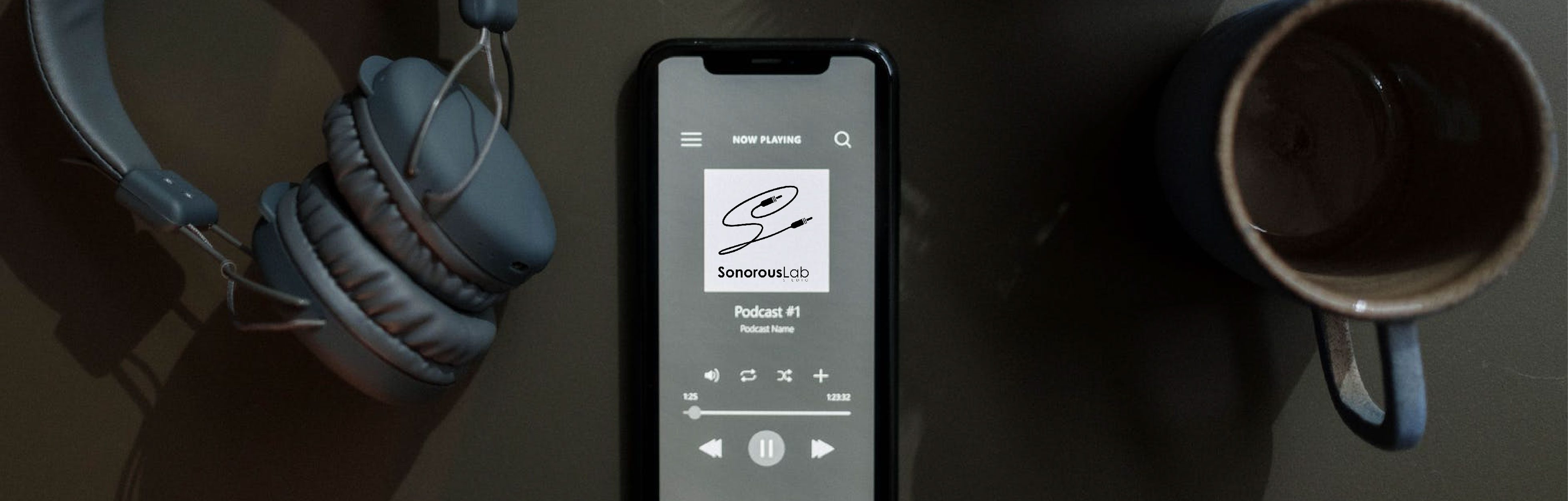 A smartphone displaying a podcast player interface, with headphones beside it and a coffee cup in the background.