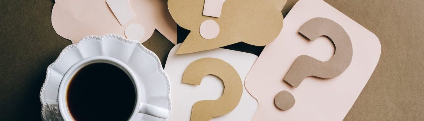 question marks on paper crafts beside coffee drink