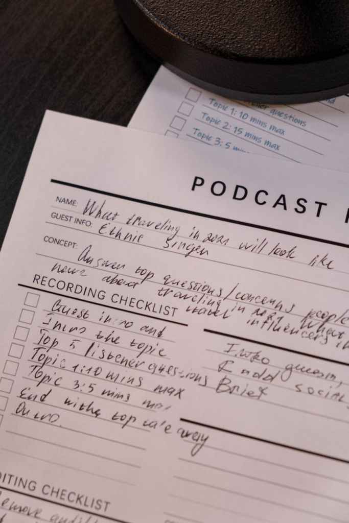 writing on paper with podcast planner