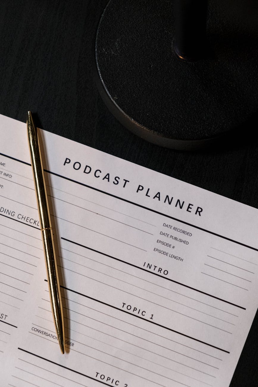 pen on paper with podcast planner