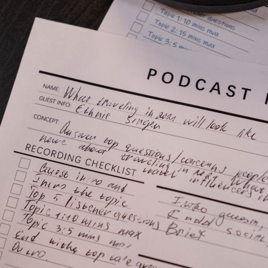 writing on paper with podcast planner