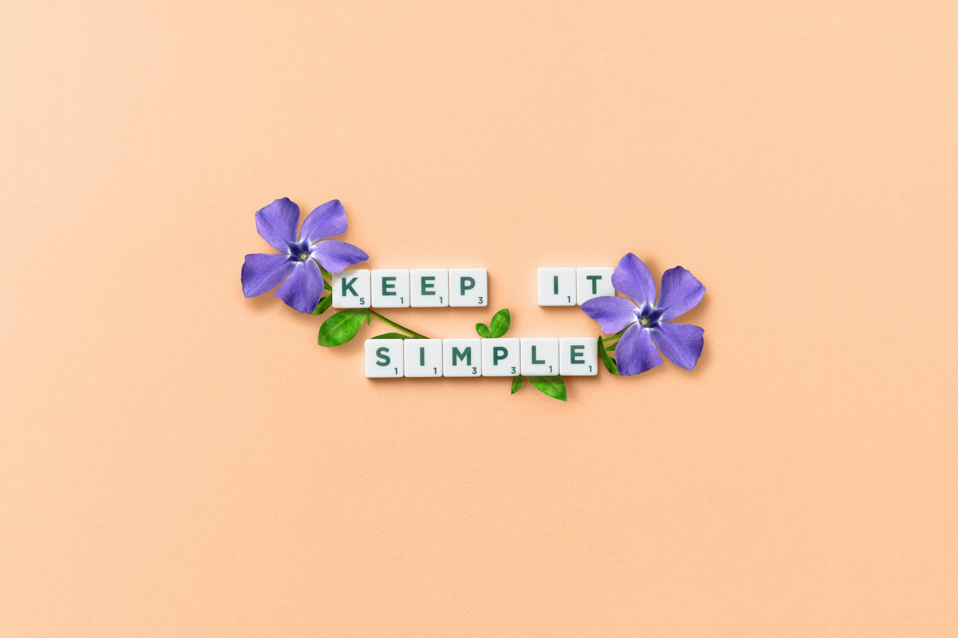 scrabble text and purple flowers on pastel background